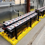 Flooded lead acid batteries on an angle with Eagle Eye Power Solutions spill containment pillows under the battery racks.