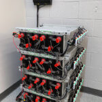 4 stacks of batteries in battery room with Eagle Eye Power Solutions Vigilant battery monitoring system attached