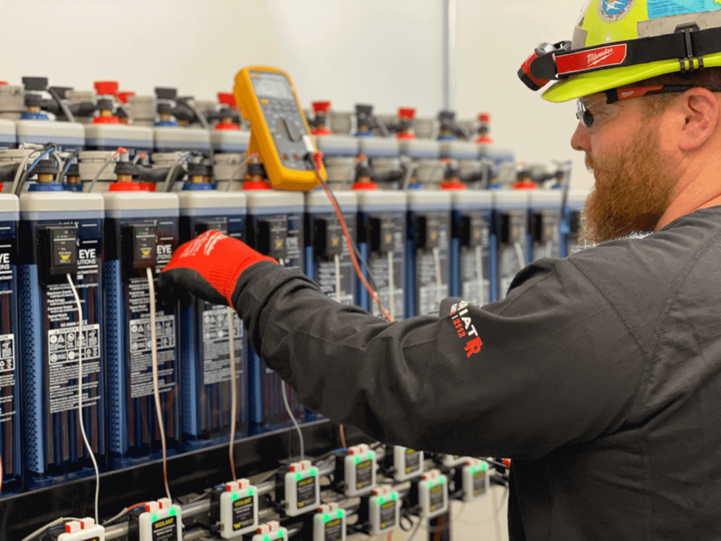Eagle Eye Services technician installing the Eagle Eye Power Solutions Vigilant Battery Monitoring system.