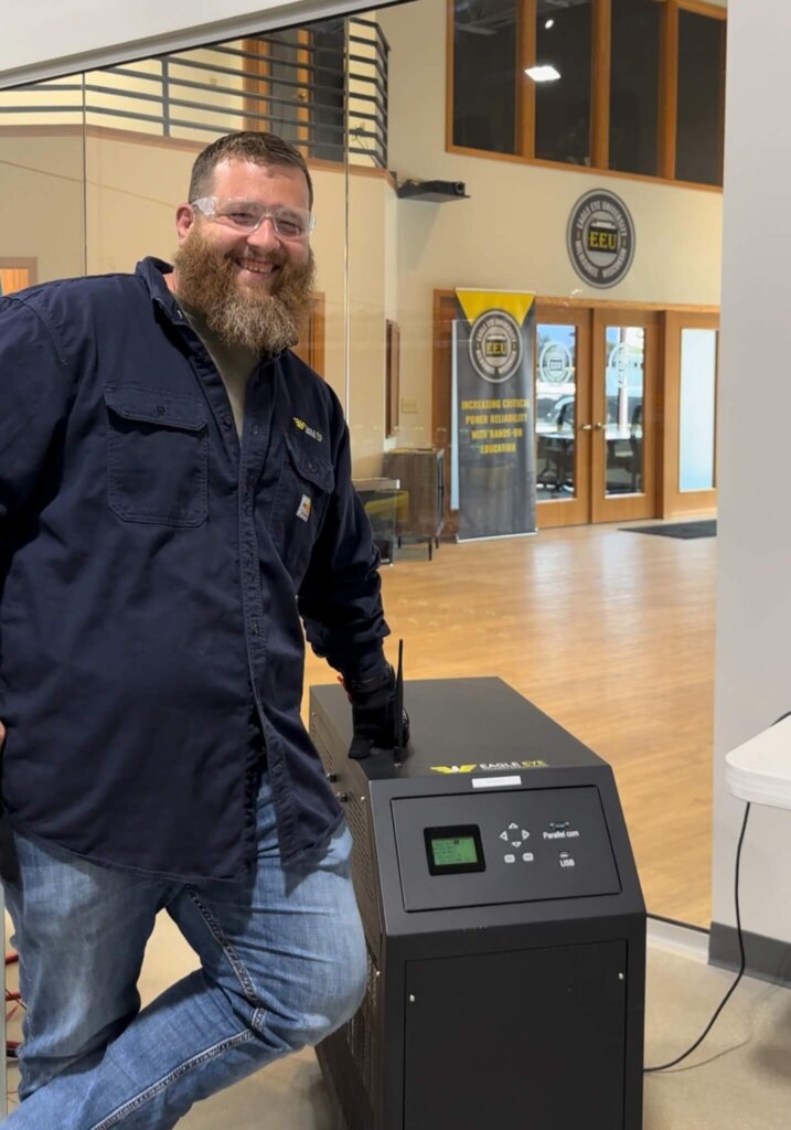 Chris Melby, Service Project Manager of Eagle Eye Services with the BC-2500 Battery Charger in the Atrium of Eagle Eye Power Solutions headquarters in Mequon, WI.