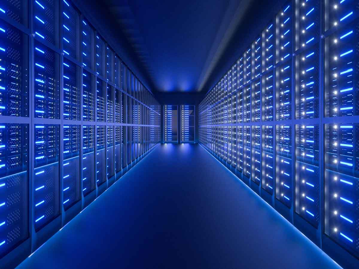 Data center hallway featuring rows of illuminated server racks with blue LED lighting, reflecting off the glossy floor, creating a futuristic and high-tech ambiance.