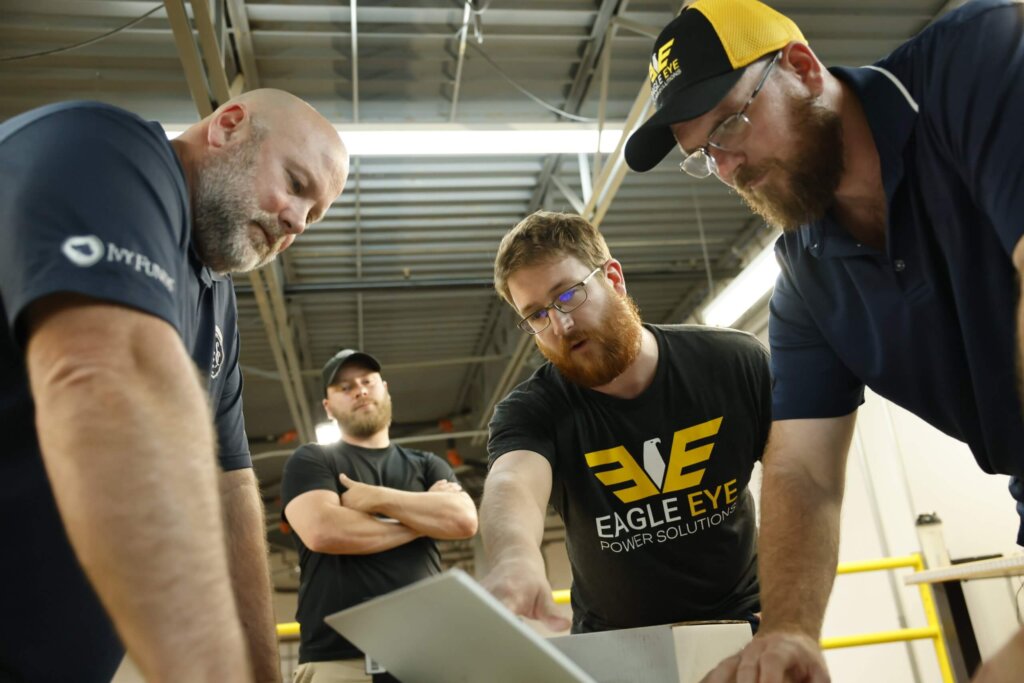 People analyzing information on laptop.