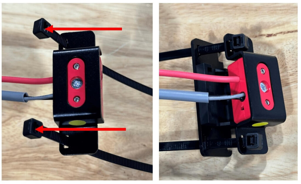 Two side-by-side images showing the proper orientation and installation of cable ties into a battery cable clamp body. Red arrows highlight the direction in which the cable ties should be inserted through the clamp body holes, with tie heads positioned on the wire-entry side. The second image displays the support backplate being slid into place behind the clamp using the cable ties for alignment. Red and gray wires are connected through the clamp, demonstrating proper cable management for battery monitoring equipment.